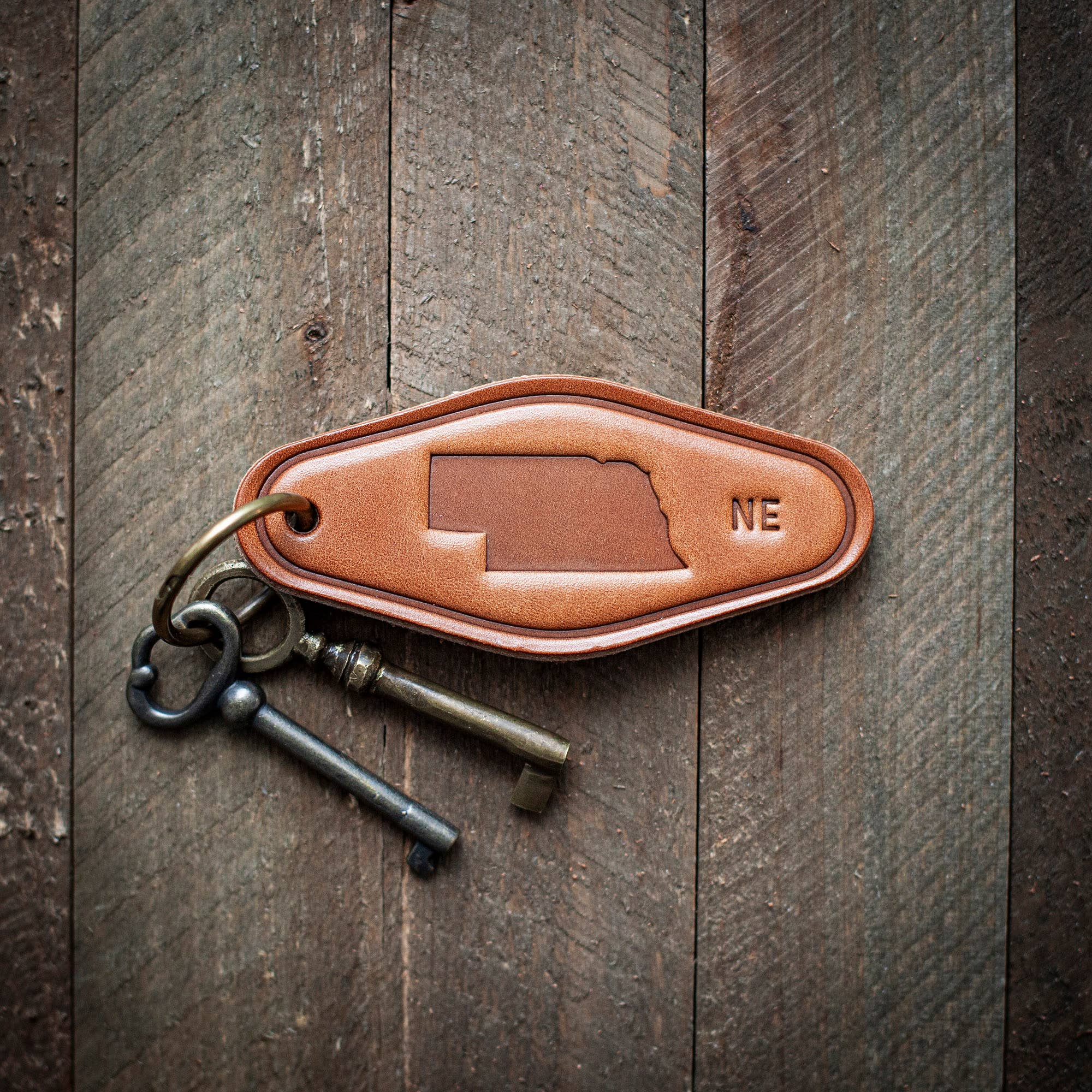 Nebraska State Silhouette Leather Keychain Motel Style